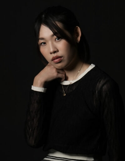 黒背景で撮影した女性モデルのプロフィール写真